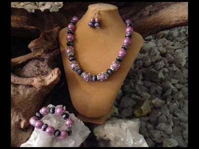 16. Chunky & Bold Ceramic w/Purple Roses $49.95
Bracelet $23.95 Earrings $12.95 16. Chunky & Bold Ceramic w/Purple Roses